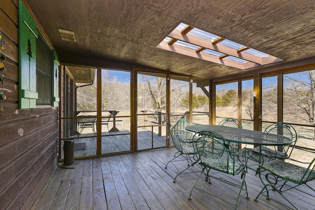 unfurnished sunroom with a skylight and a healthy amount of sunlight