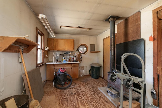 kitchen featuring electric panel, brown cabinets, and light countertops