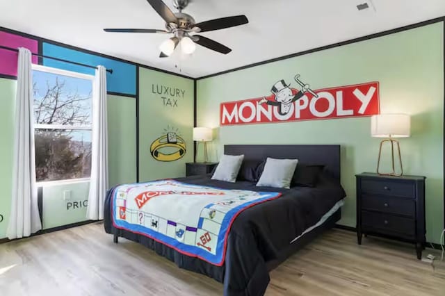 bedroom featuring crown molding, ceiling fan, and wood finished floors