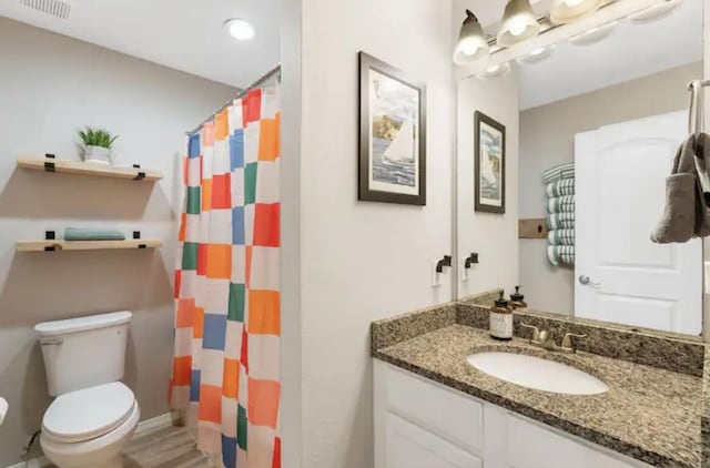 full bath with visible vents, toilet, vanity, and a shower with shower curtain