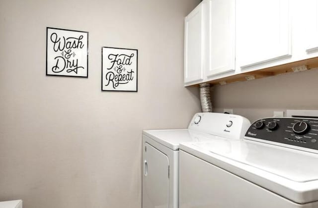 clothes washing area with cabinet space and washing machine and clothes dryer