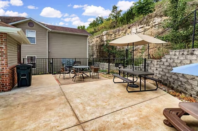 view of patio / terrace featuring outdoor dining area and fence