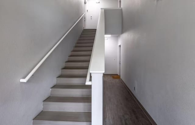 staircase featuring wood finished floors