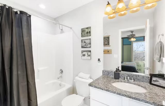 full bath featuring connected bathroom, shower / bath combo with shower curtain, toilet, ceiling fan with notable chandelier, and vanity