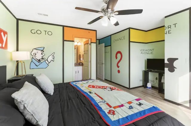 bedroom featuring visible vents, ornamental molding, ceiling fan, and wood finished floors