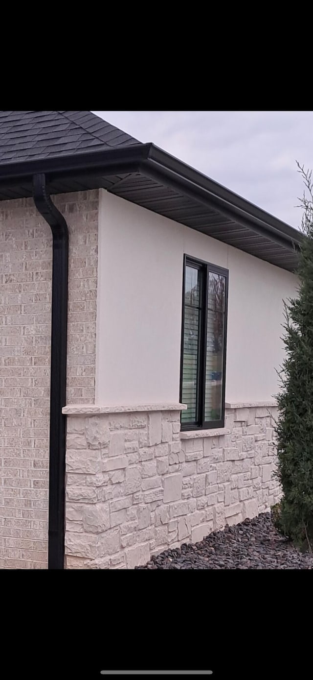 view of side of property with stone siding and stucco siding