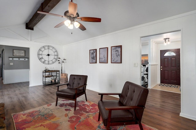 living area with lofted ceiling with beams, a ceiling fan, and wood finished floors