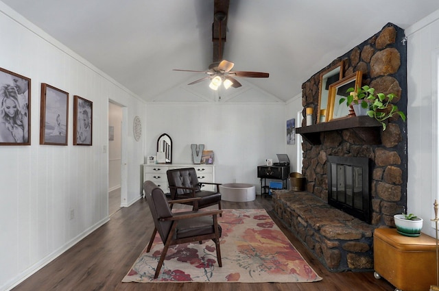 living room featuring a stone fireplace, lofted ceiling with beams, a ceiling fan, and wood finished floors