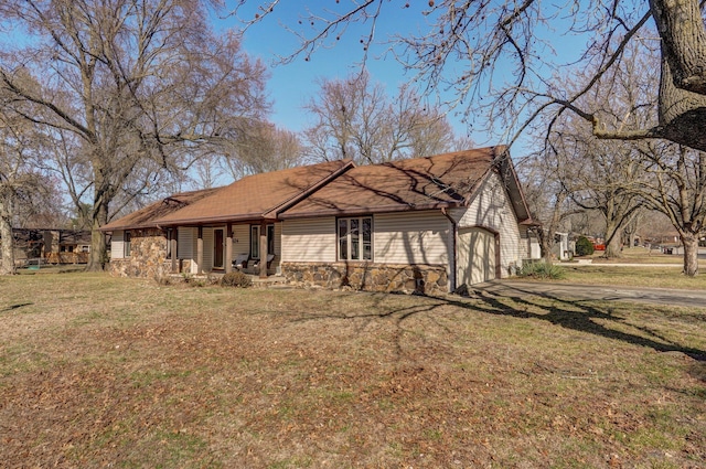 exterior space featuring a garage, driveway, and a yard