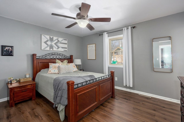 bedroom with baseboards, dark wood-style floors, and a ceiling fan