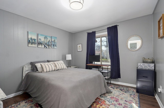 bedroom with baseboards and wood finished floors