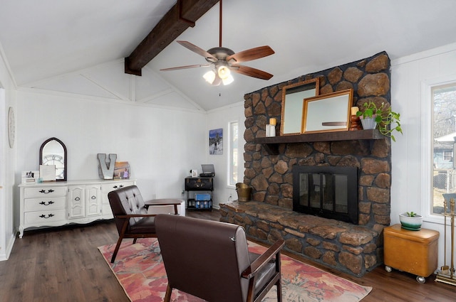 living area featuring lofted ceiling with beams, a ceiling fan, dark wood finished floors, and a fireplace