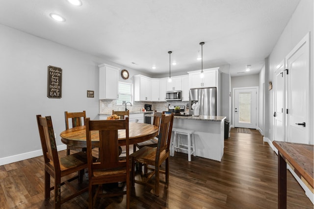 dining area with recessed lighting, baseboards, and dark wood finished floors