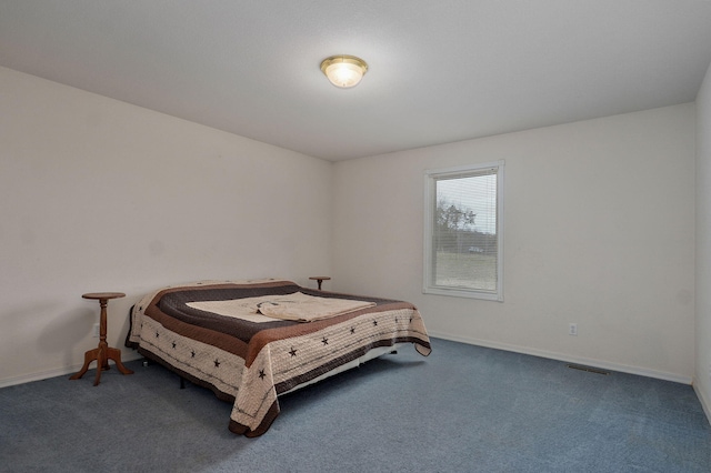 bedroom with visible vents, baseboards, and carpet