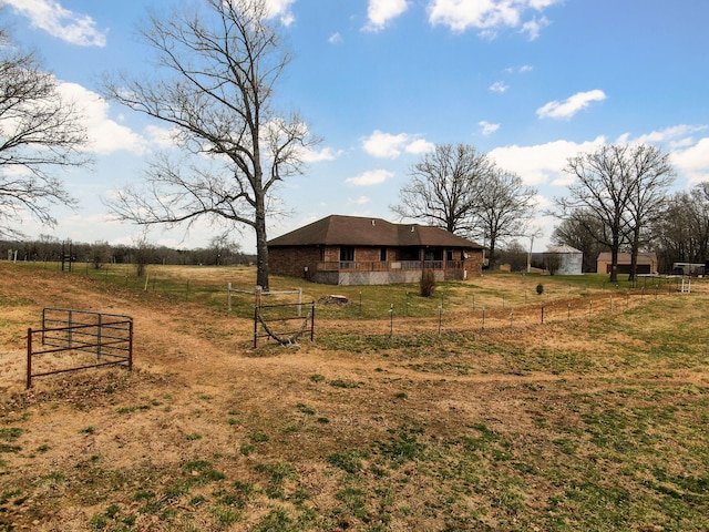 view of yard featuring a rural view and fence