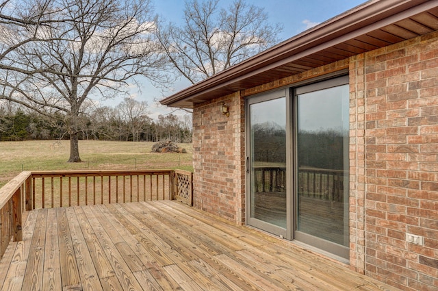 wooden terrace with a lawn