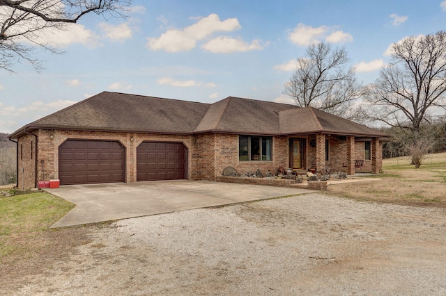 ranch-style house featuring a garage, brick siding, driveway, and a shingled roof