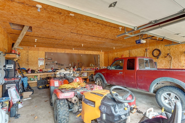 garage with a workshop area and a garage door opener