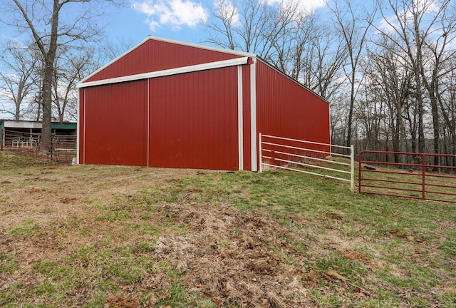 view of pole building featuring a lawn and fence