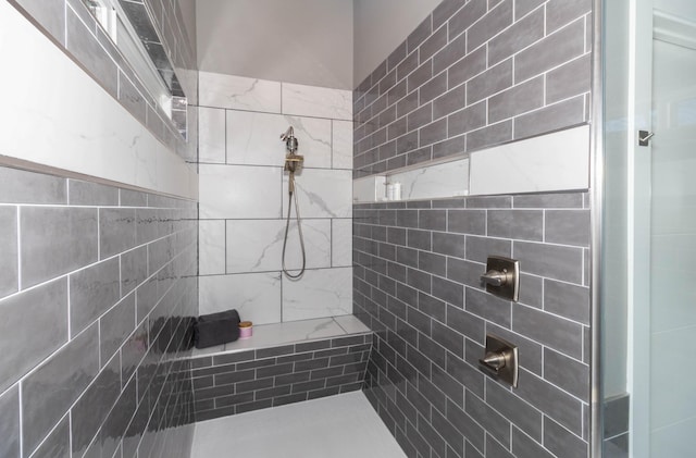 full bath with a tile shower