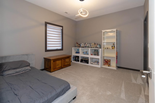 bedroom with visible vents and carpet