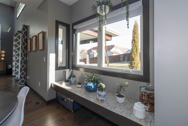 dining area with visible vents, baseboards, and dark wood-type flooring