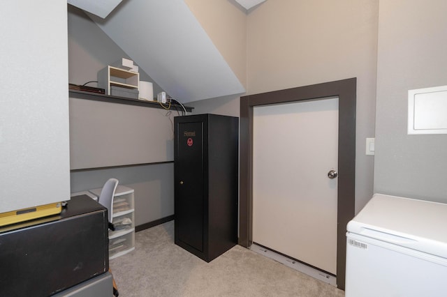 office area with carpet and vaulted ceiling