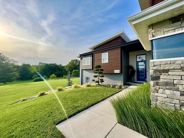 view of exterior entry with a lawn