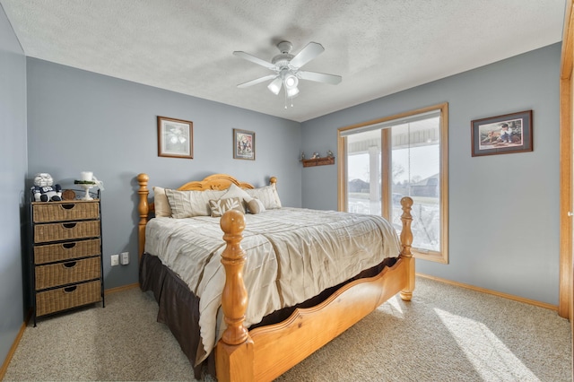 bedroom with a ceiling fan, carpet, baseboards, and a textured ceiling