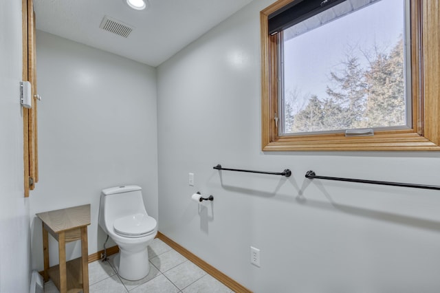 bathroom with tile patterned flooring, toilet, baseboards, and visible vents