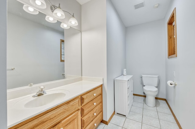 bathroom featuring tile patterned flooring, visible vents, toilet, and vanity