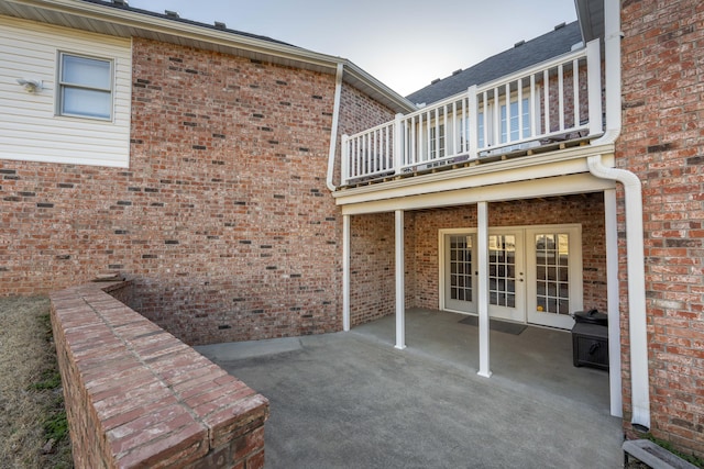 view of patio featuring french doors and a balcony