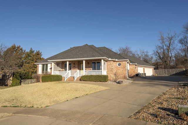 ranch-style house featuring driveway, a porch, fence, roof with shingles, and brick siding