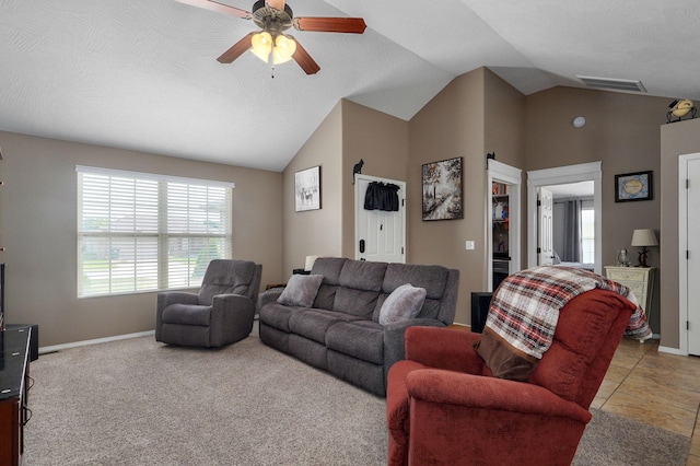 living area featuring visible vents, baseboards, a ceiling fan, and vaulted ceiling