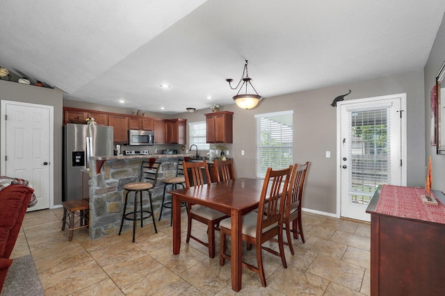 dining space with vaulted ceiling, recessed lighting, baseboards, and a textured ceiling