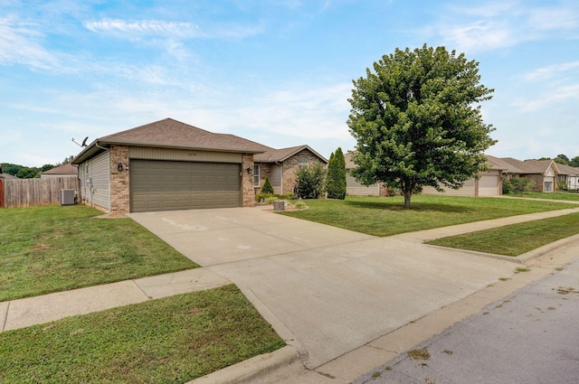 view of front of house with an attached garage, a front lawn, concrete driveway, central air condition unit, and brick siding