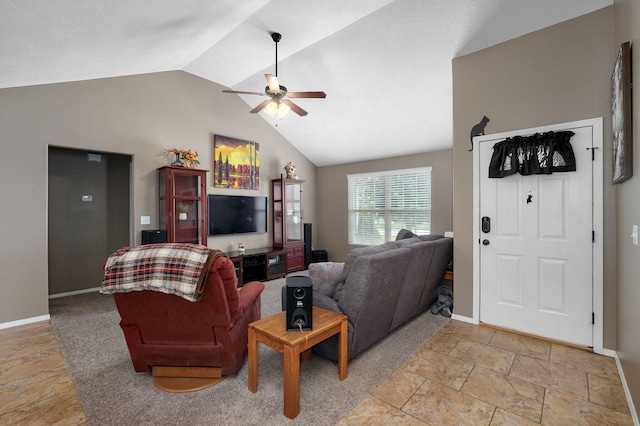 living room featuring baseboards, a ceiling fan, and vaulted ceiling