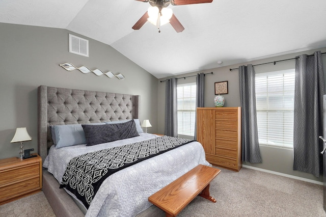 carpeted bedroom featuring visible vents, baseboards, ceiling fan, and vaulted ceiling