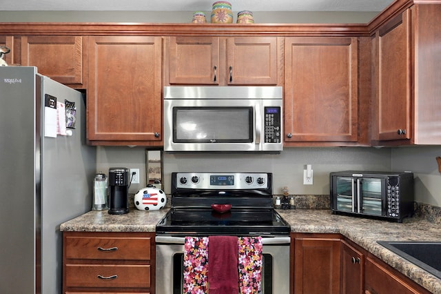 kitchen featuring a sink, brown cabinets, appliances with stainless steel finishes, and a toaster