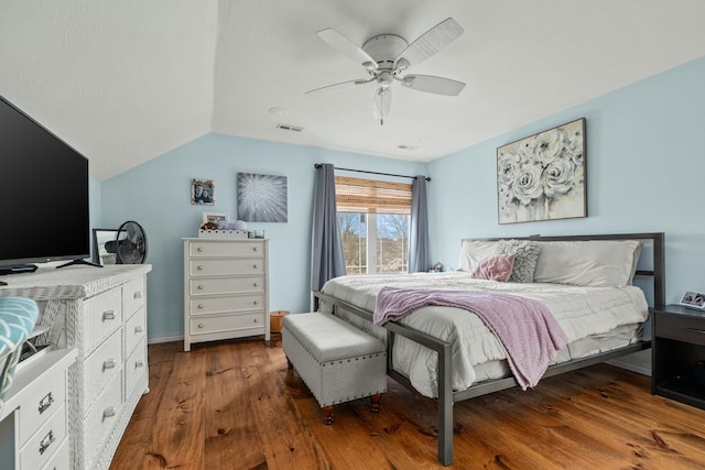 bedroom with a ceiling fan, lofted ceiling, wood finished floors, and visible vents