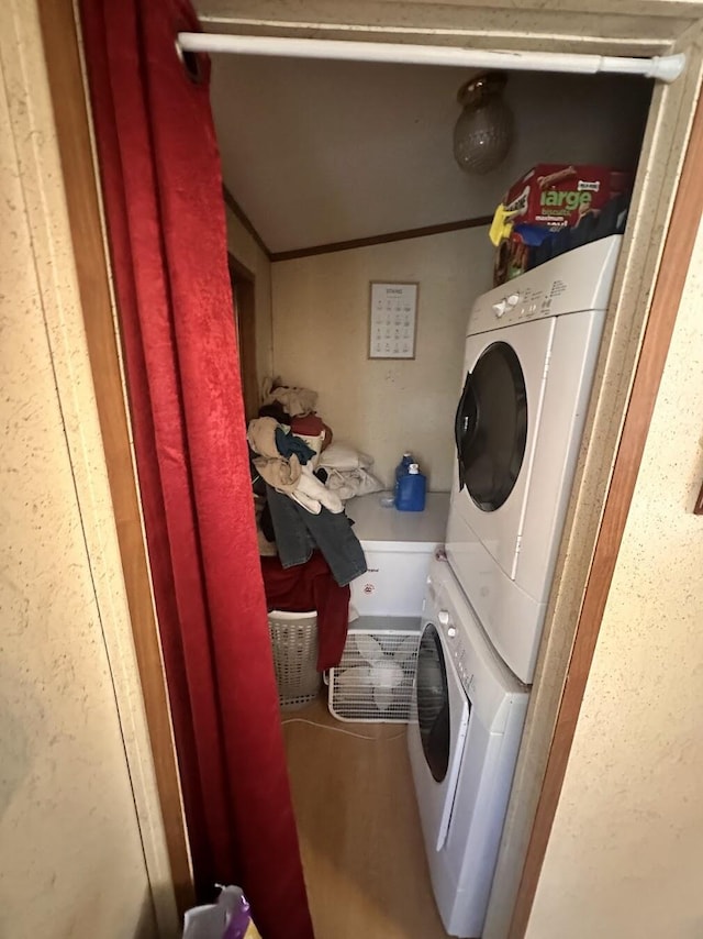 laundry area featuring laundry area and stacked washer and clothes dryer