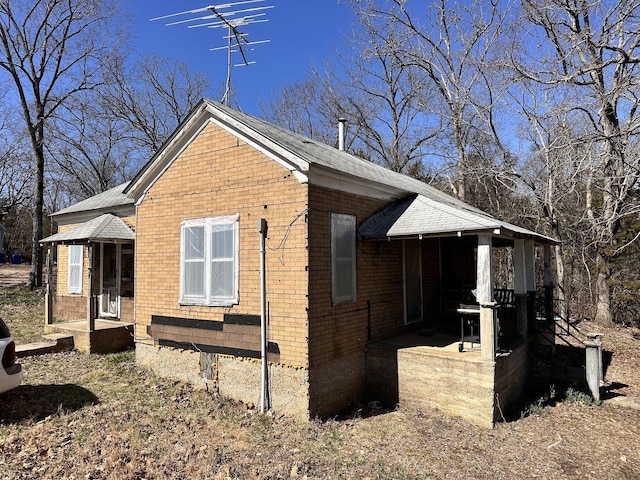 view of side of home with brick siding