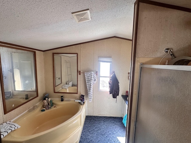 full bathroom with visible vents, a stall shower, ornamental molding, vaulted ceiling, and a textured ceiling