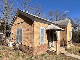 view of side of property featuring brick siding