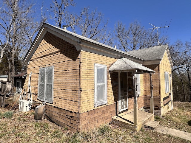 view of side of property featuring brick siding