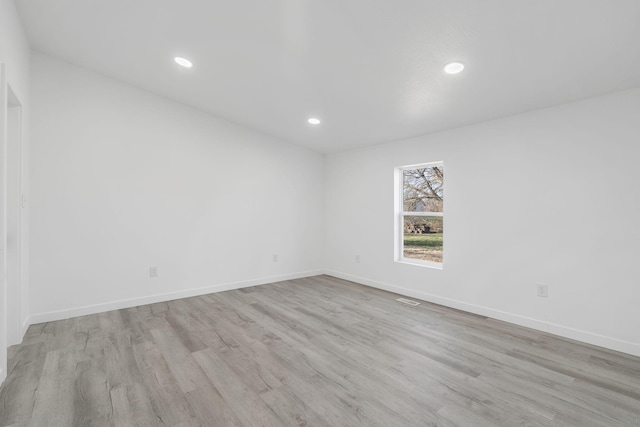 spare room with recessed lighting, visible vents, baseboards, and light wood-style floors