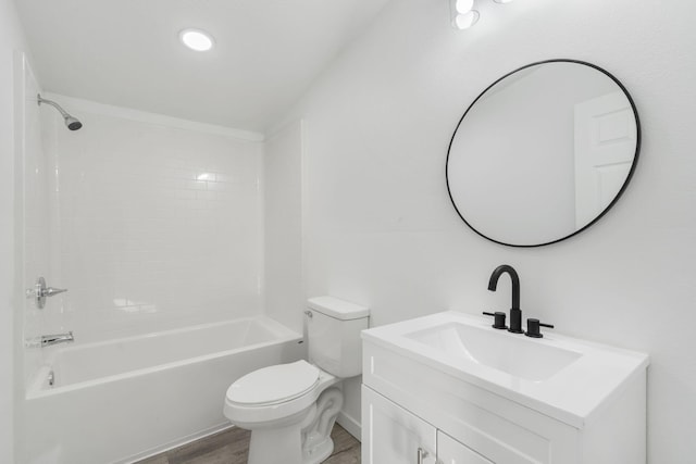 bathroom featuring vanity, toilet, wood finished floors, and shower / bath combination