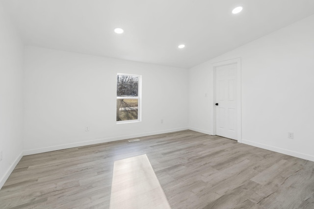 empty room featuring recessed lighting, light wood-style flooring, and baseboards