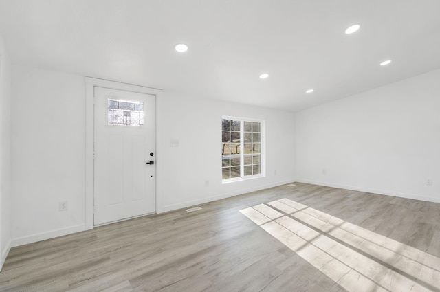 foyer entrance with light wood finished floors, visible vents, recessed lighting, and baseboards