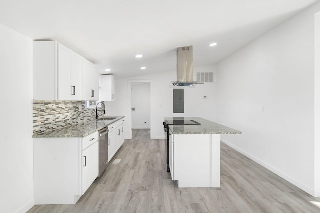 kitchen featuring island exhaust hood, light stone counters, dishwasher, and a sink